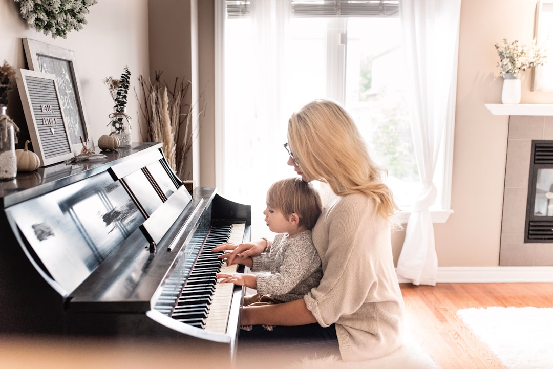 person playing upright piano