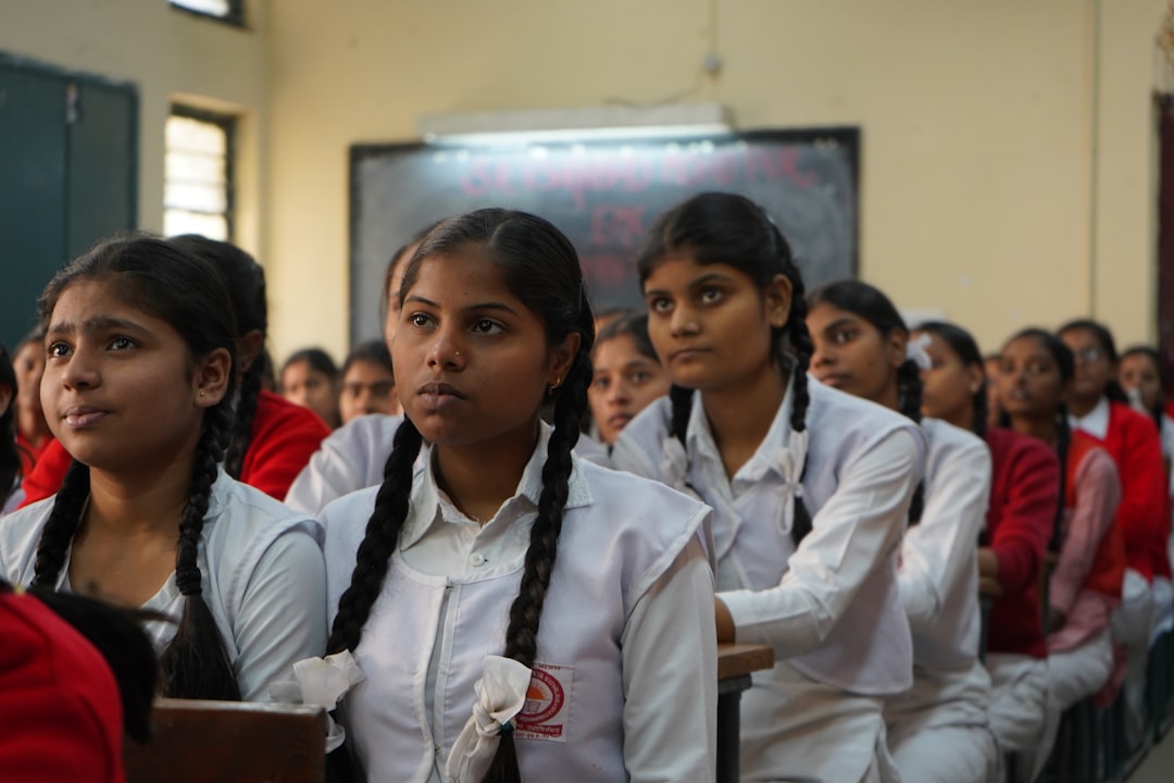 girls sitting in a classroom with eyes closed
