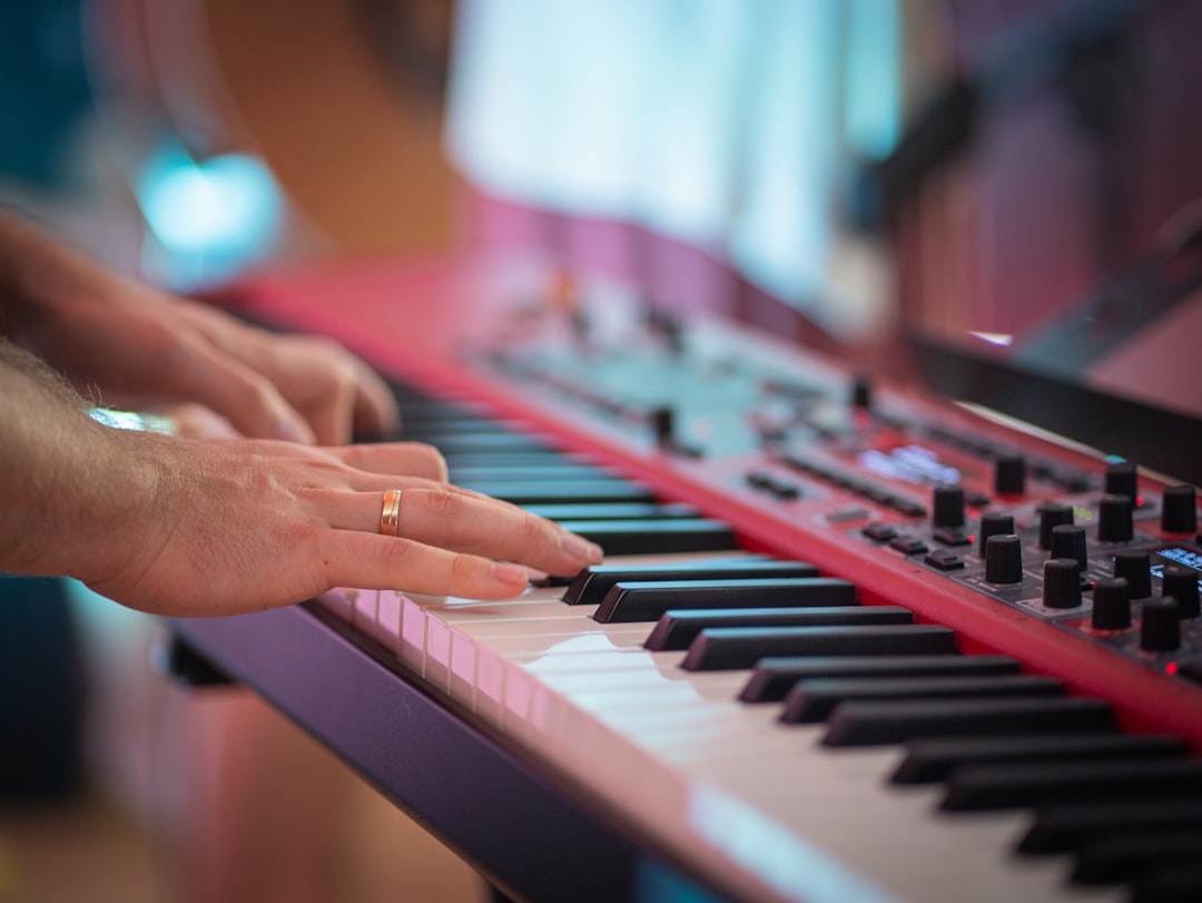 Someone is playing the piano with two keyboards.