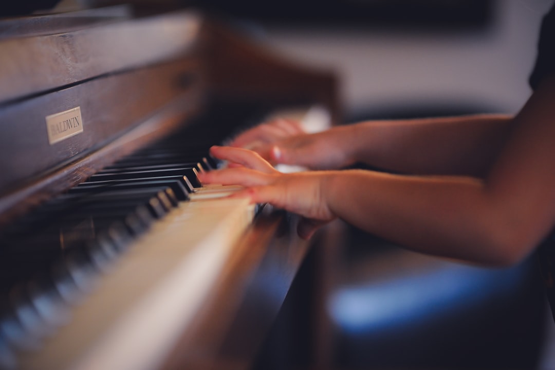 a person playing a piano with their hands