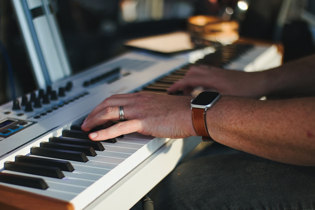 a close up of a piano keyboard with a blurry background
